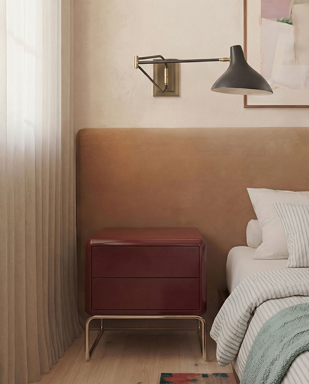 Upholstered headboard, bespoke bedside cabinet and wall-mounted reading light within the principal bedroom, framed by full-height sheer curtains.