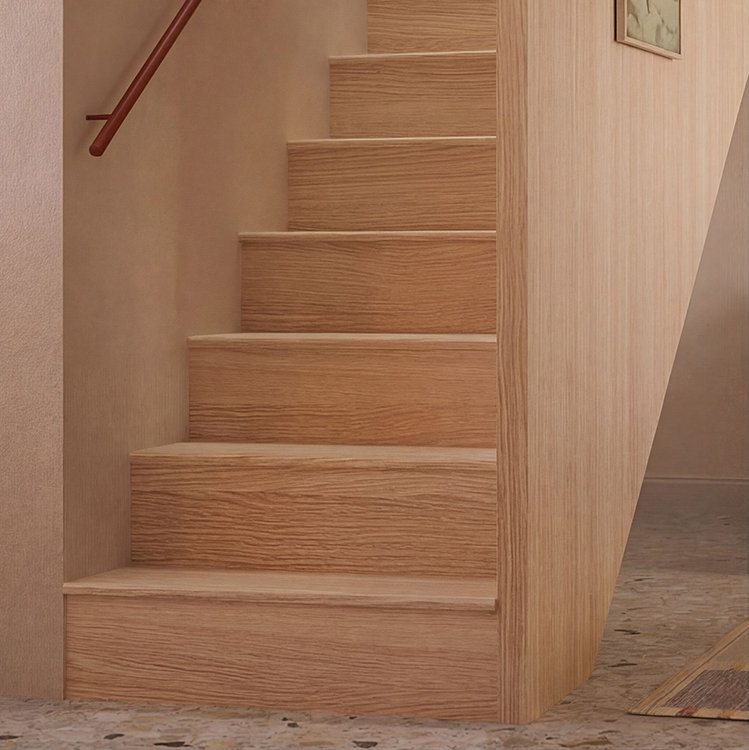 Oak staircase with timber-clad balustrade and integrated handrail forming the central circulation route through the apartment.