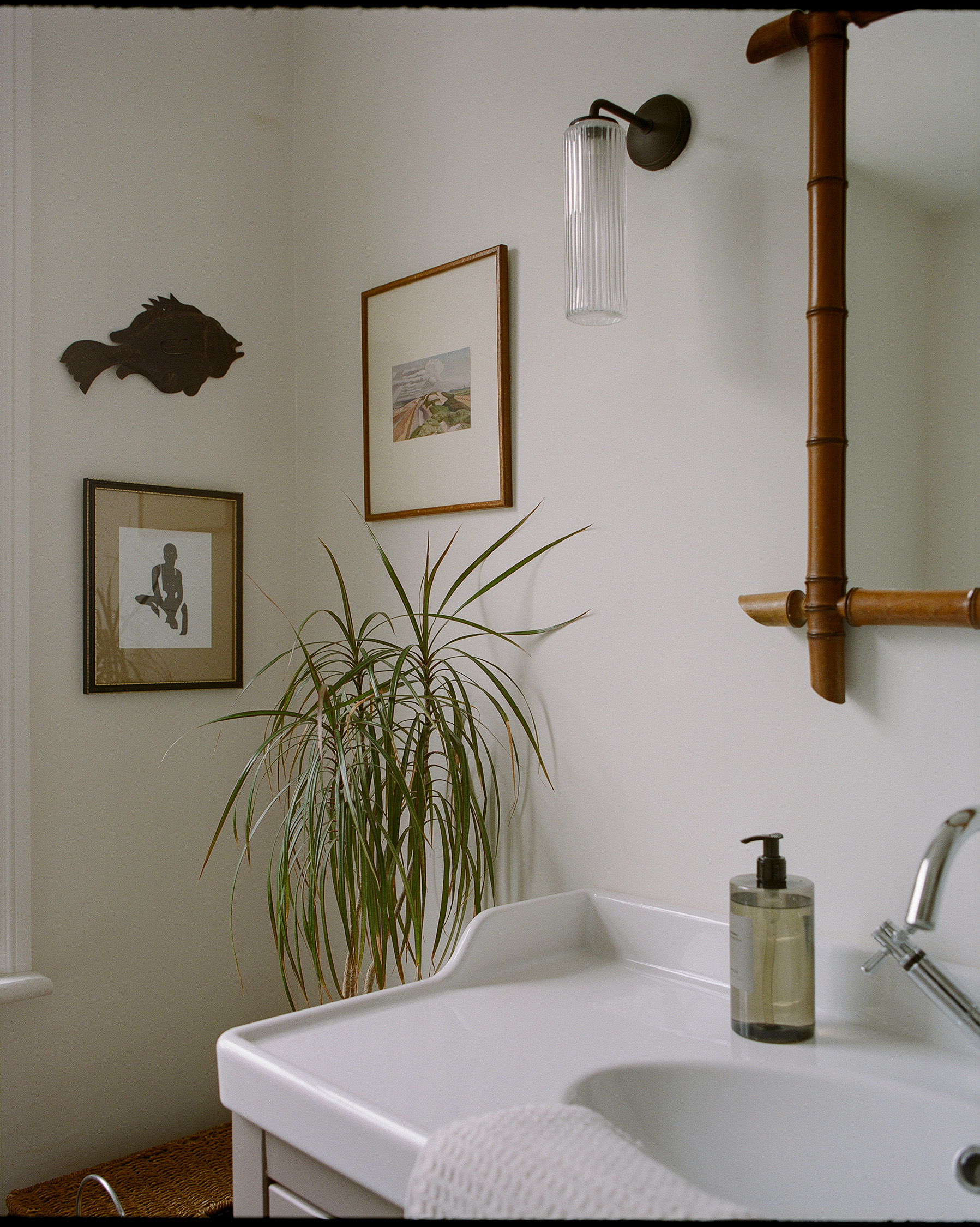 Bathroom vanity with ceramic basin, timber-framed mirror and soft natural styling.
