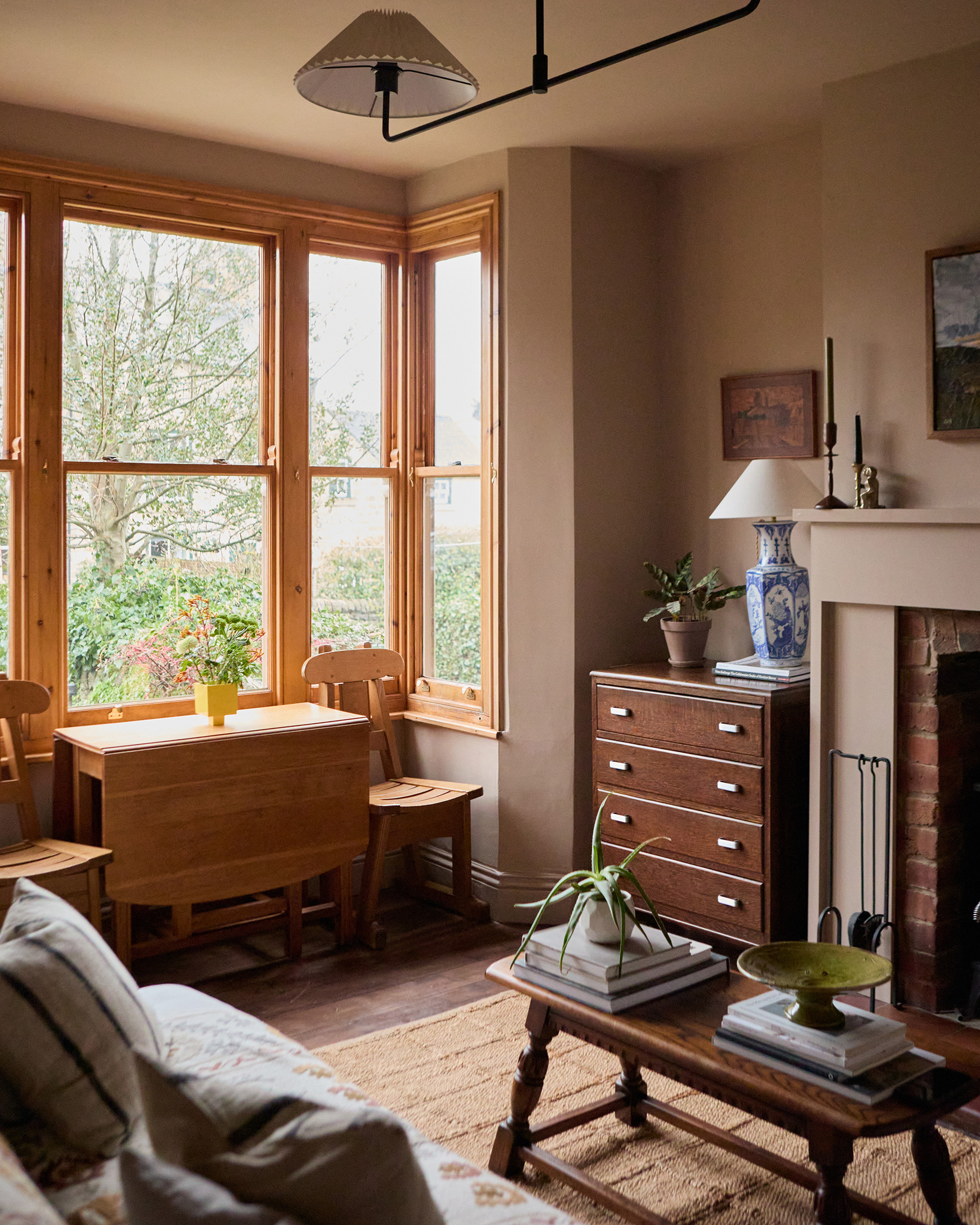 Living room bay window with timber joinery, drop-leaf table and views to the front garden.